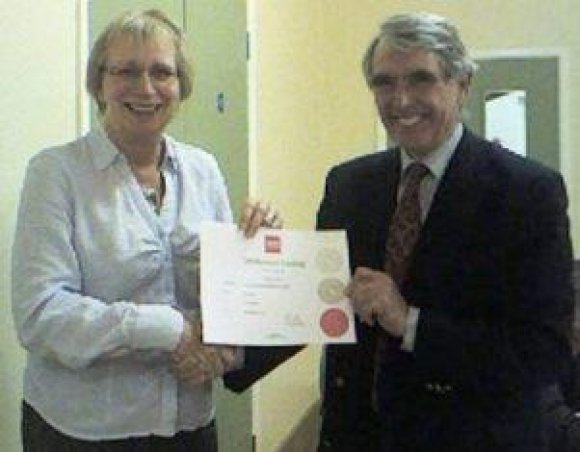 2008 Parish Council Chair Ken Waterfall presents Coucillor Virginia Toone with the Cerficate she was awarded to enable her to look after the safety on the Bob Bown Playing Field.